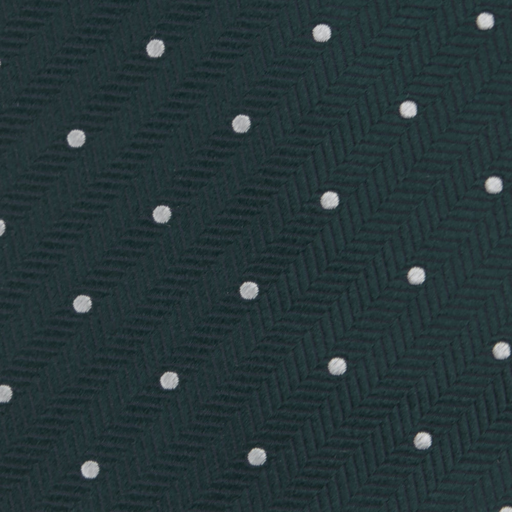 The Forest Green and White Small Spot Herringbone Silk Tie by Turnbull & Asser features a dark green woven herringbone pattern with small white spots, crafted from fine English silk and shown rolled up on a white background.