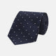 The Navy and White Small Spot Herringbone Silk Tie from Turnbull & Asser features a classic navy herringbone pattern with small white polka dots, offering an elegant look suitable for any occasion.