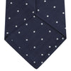 View 4 of product The Navy and White Small Spot Herringbone Silk Tie from Turnbull & Asser features a classic navy herringbone pattern with small white polka dots, offering an elegant look suitable for any occasion.