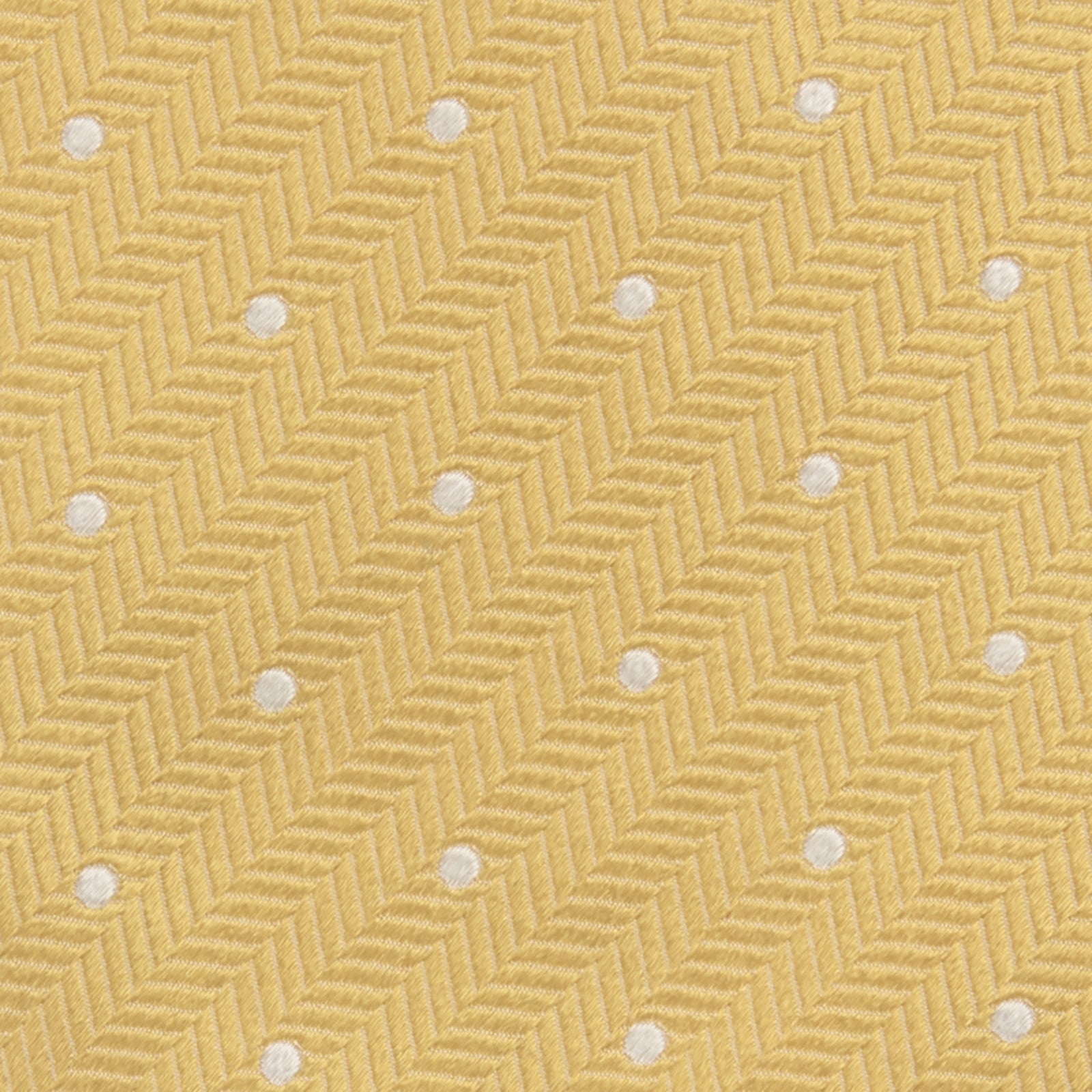 View 3 of product The Turnbull & Asser Gold and White Small Spot Herringbone Silk Tie is crafted from fine English silk, featuring a gold herringbone weave with white polka dots, and is shown rolled up on a white background.