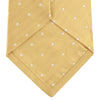 View 4 of product The Turnbull & Asser Gold and White Small Spot Herringbone Silk Tie is crafted from fine English silk, featuring a gold herringbone weave with white polka dots, and is shown rolled up on a white background.