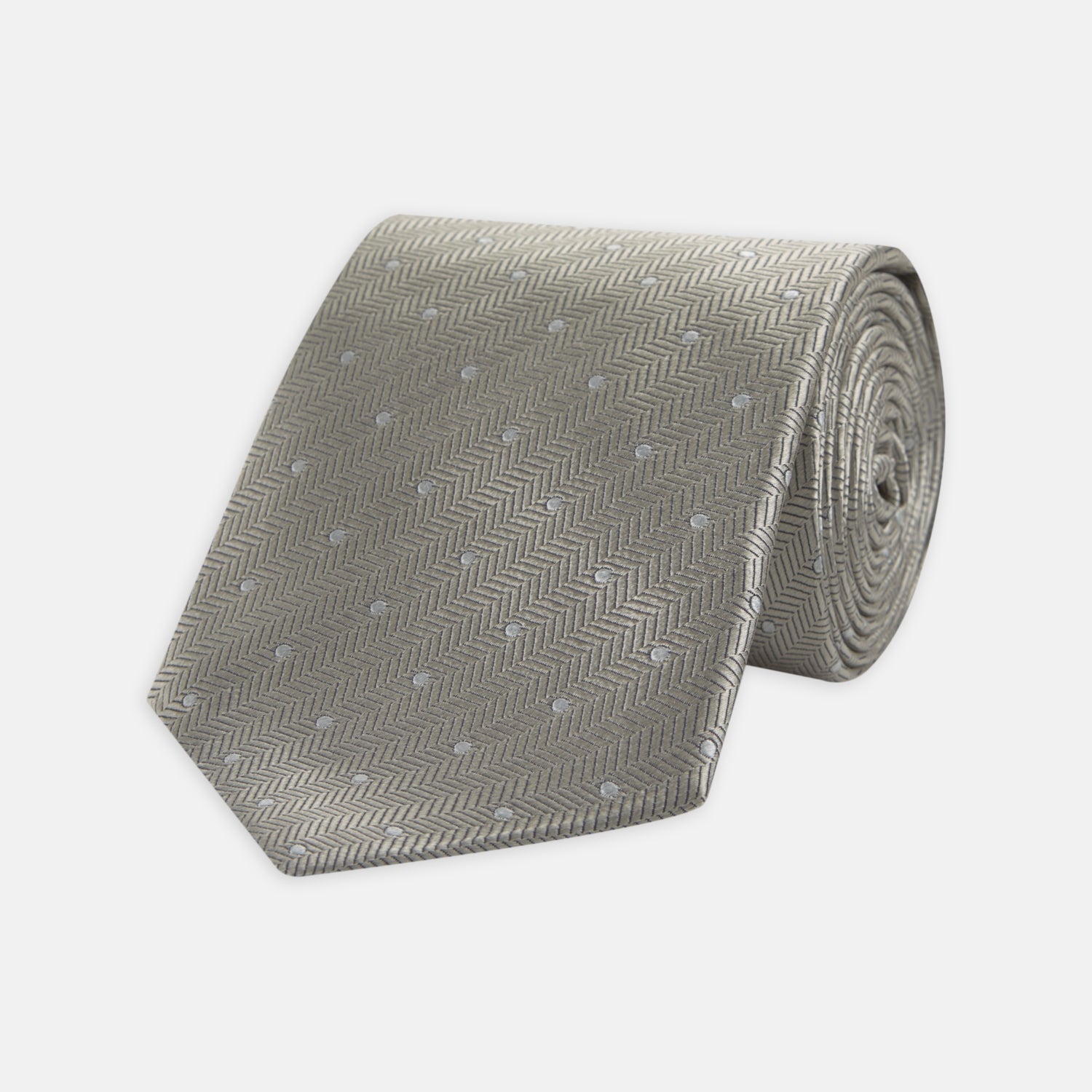 View 1 of product The Turnbull & Asser Silver and White Small Spot Herringbone Silk Tie features a subtle pattern of small, evenly spaced light dots and is expertly crafted from fine English silk.