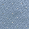 View 3 of product The Turnbull & Asser Ice Blue and White Small Spot Herringbone Silk Tie features a refined herringbone weave with subtle white spots, displayed elegantly against a plain white background.