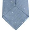View 4 of product The Turnbull & Asser Ice Blue and White Small Spot Herringbone Silk Tie features a refined herringbone weave with subtle white spots, displayed elegantly against a plain white background.