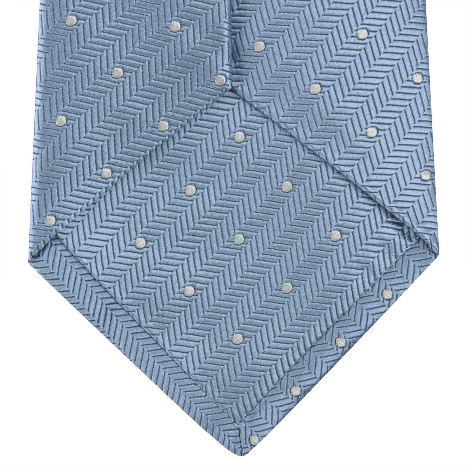 View 4 of product The Turnbull & Asser Ice Blue and White Small Spot Herringbone Silk Tie features a refined herringbone weave with subtle white spots, displayed elegantly against a plain white background.