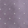 View 3 of product The Turnbull & Asser Lilac and White Small Spot Herringbone Silk Tie, crafted from fine English silk, is neatly rolled and displayed on a plain white background.