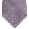 View 4 of product The Turnbull & Asser Lilac and White Small Spot Herringbone Silk Tie, crafted from fine English silk, is neatly rolled and displayed on a plain white background.