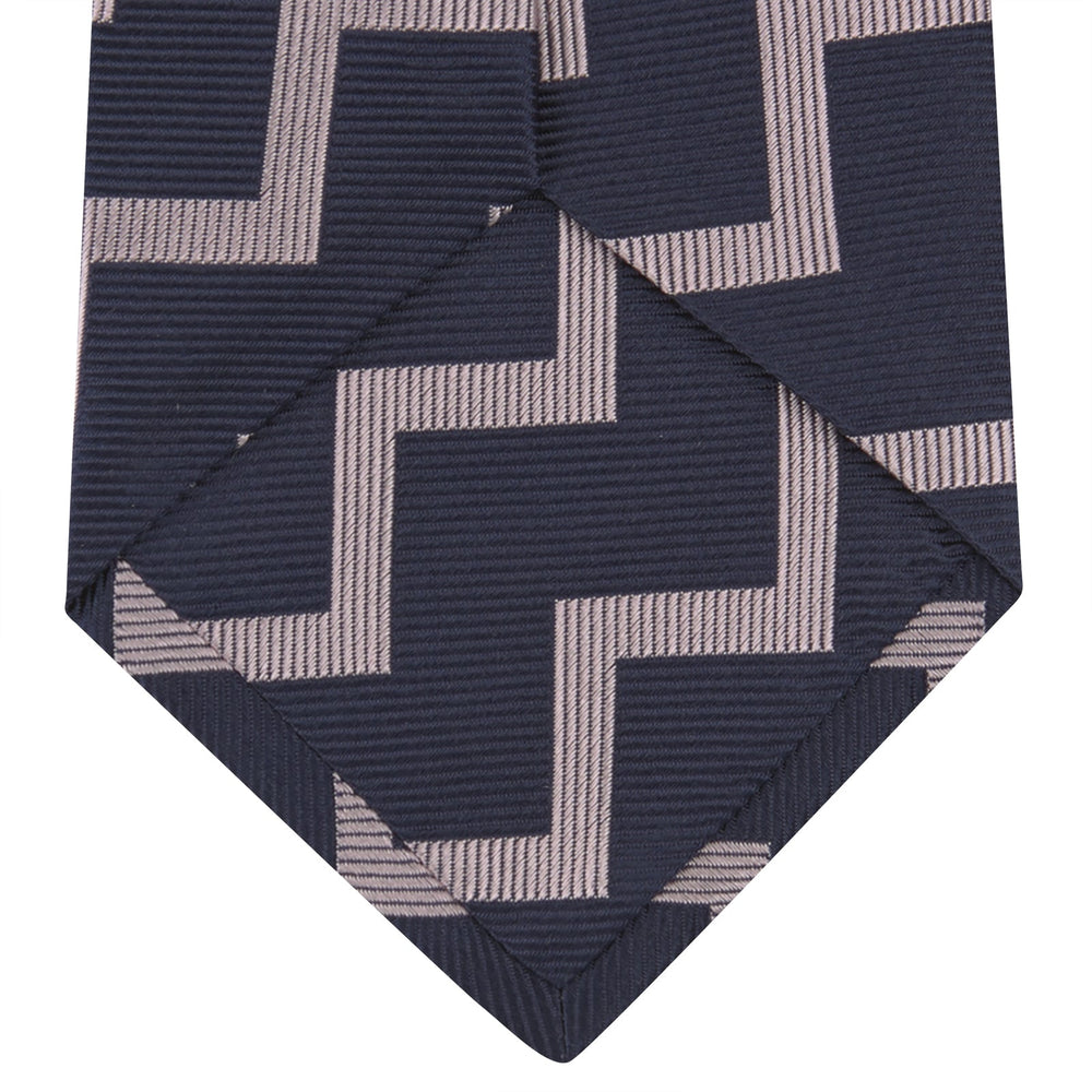 The Turnbull & Asser Navy and Rose Striped Zigzag Silk Tie features a bold zigzag pattern and is shown against a plain white background, making it an ideal accessory for the modern gentleman.