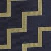 View 3 of product The Navy and Gold Striped Zigzag Silk Tie by Turnbull & Asser features a bold geometric pattern—an essential modern accessory shown rolled up with the pointed end forward on a white background.