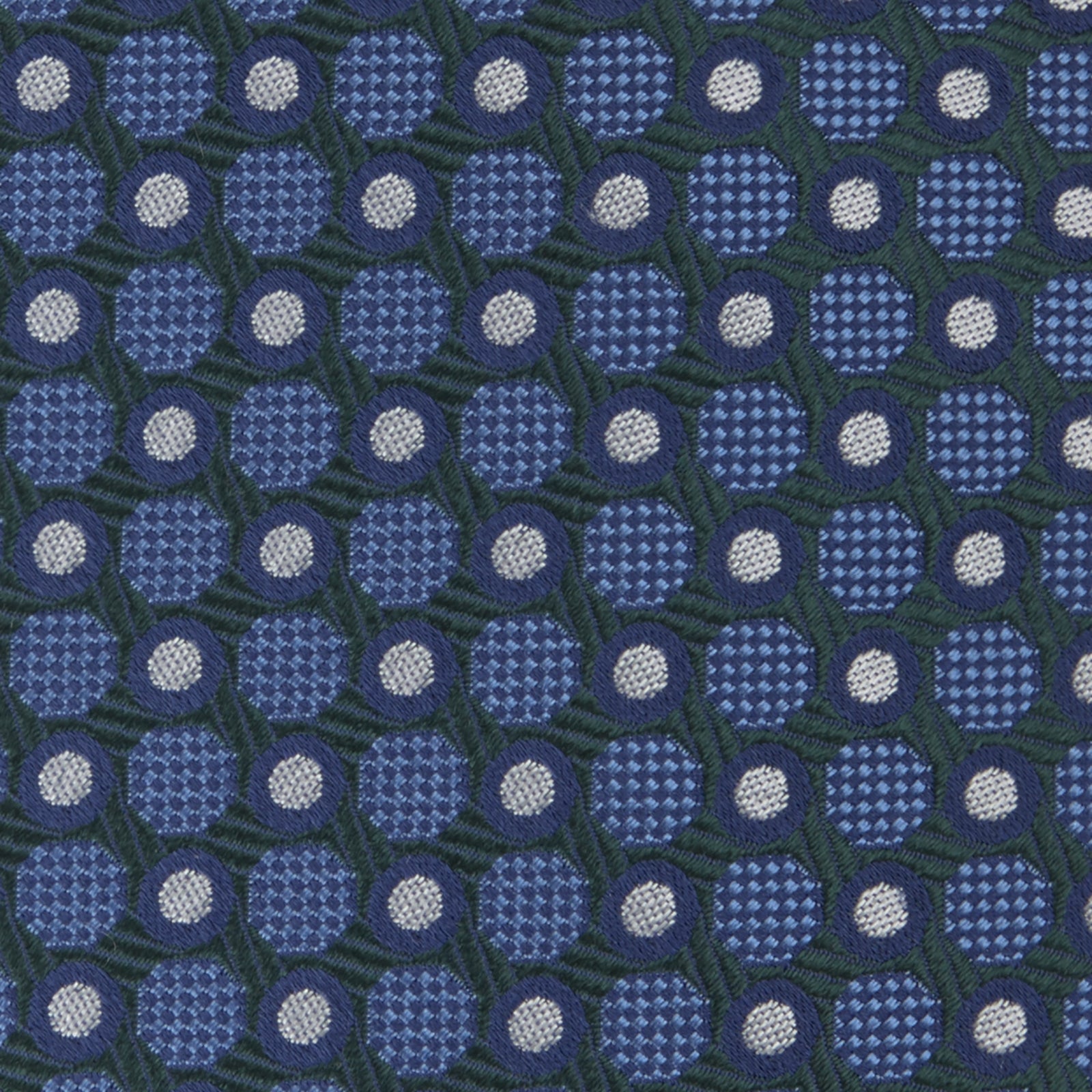View 3 of product Turnbull & Asser’s Forest Green and Blue Circle and Spot Silk Tie, rolled on a white background, features a refined pattern—an elegant classic for any office shirt.