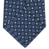 View 4 of product Turnbull & Asser’s Forest Green and Blue Circle and Spot Silk Tie, rolled on a white background, features a refined pattern—an elegant classic for any office shirt.