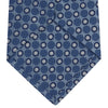 View 4 of product The Turnbull & Asser Blue Circle and Spot Silk Tie features a refined pattern of light blue and silver circles—ideal for pairing with an office shirt, elegantly displayed rolled on a plain white background.