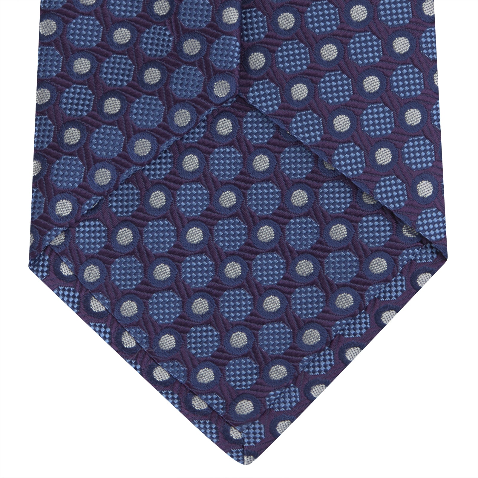 View 4 of product The Turnbull & Asser Plum and Blue Circle and Spot Silk Tie, shown rolled up on a white background, features a classic pattern—an elegant choice to complement any office shirt.