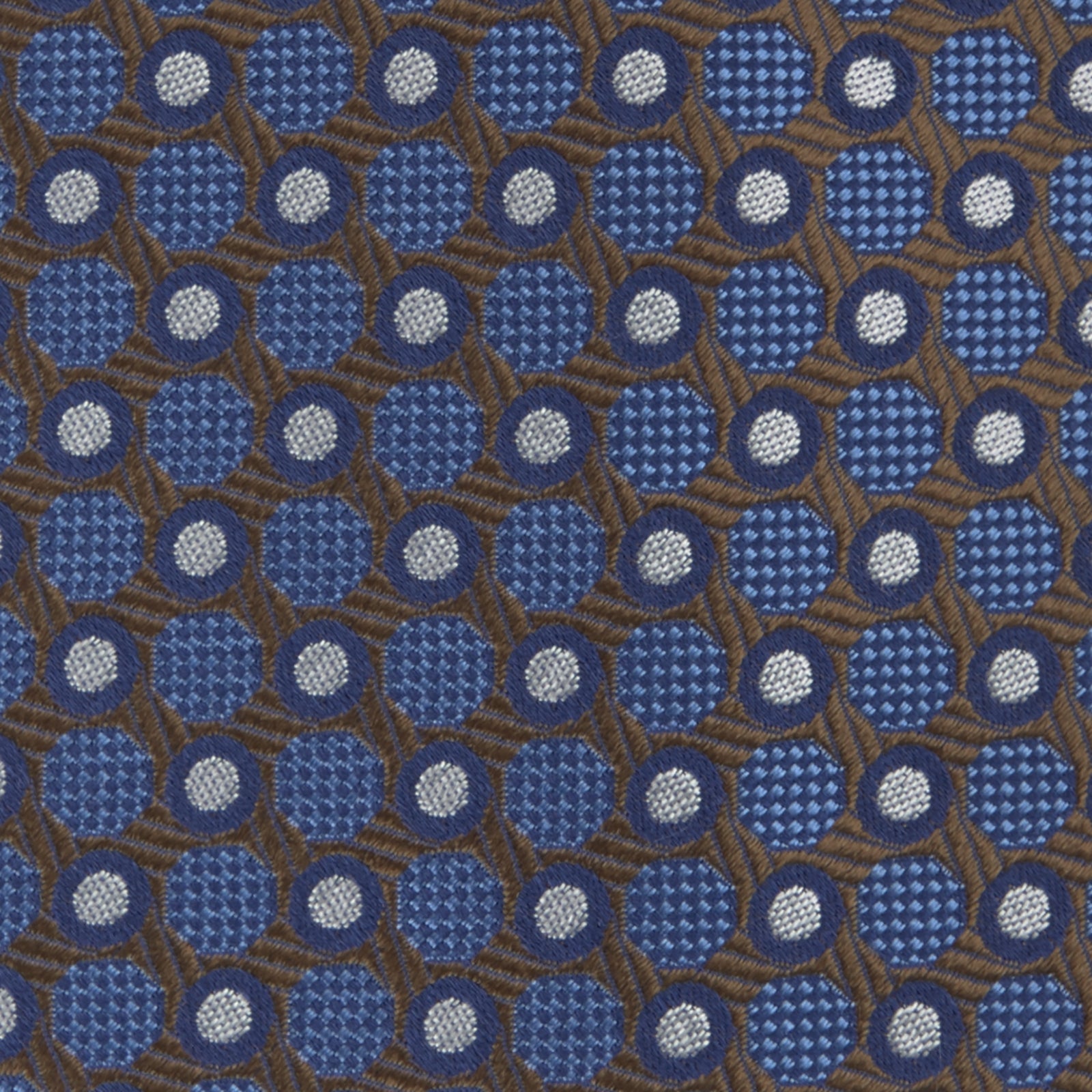 View 3 of product The Turnbull & Asser Brown and Blue Circle and Spot Silk Tie features a repeating pattern of brown and blue spots, ideal for office wear, shown on a white background.