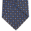 View 4 of product The Turnbull & Asser Brown and Blue Circle and Spot Silk Tie features a repeating pattern of brown and blue spots, ideal for office wear, shown on a white background.