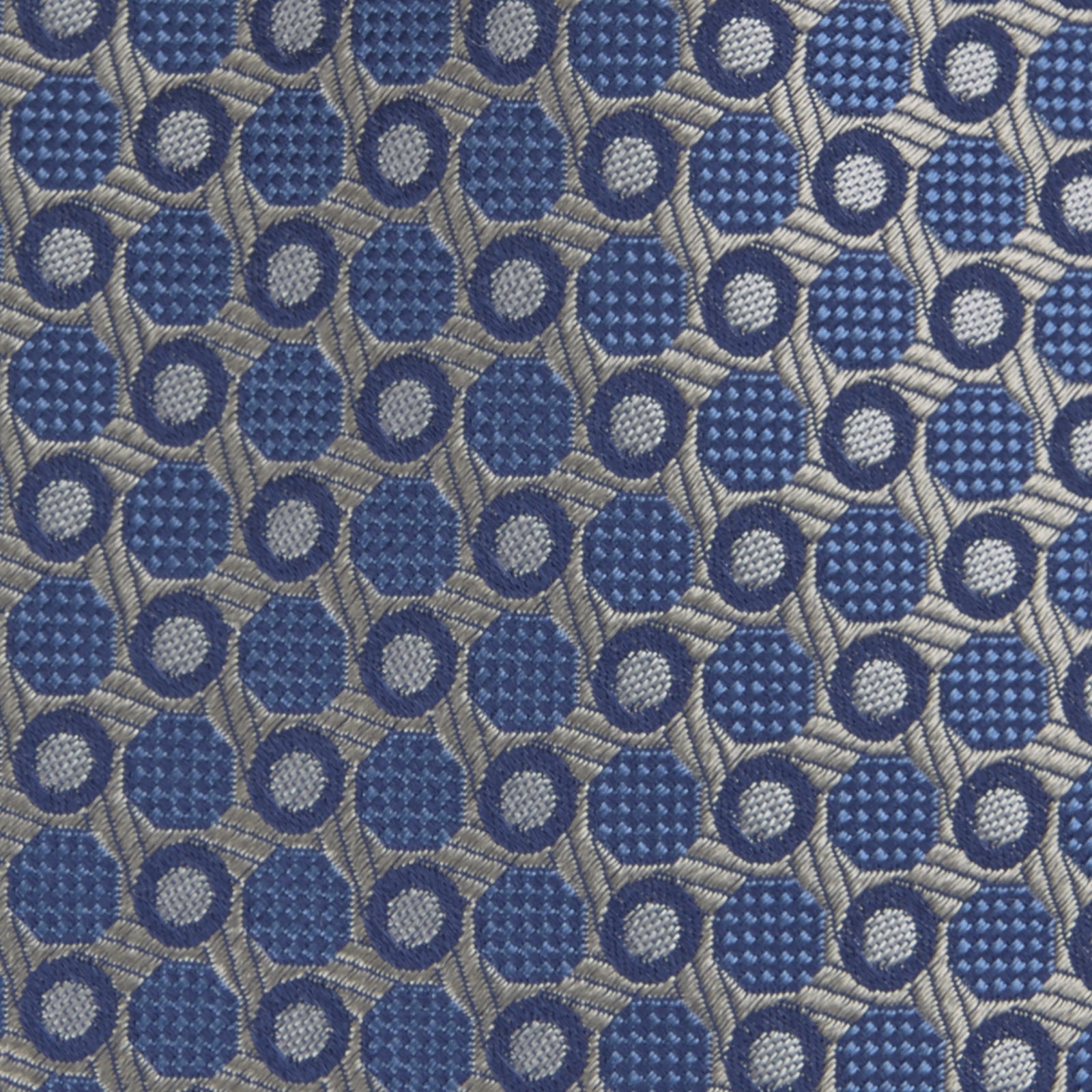 View 3 of product The Turnbull & Asser Silver and Blue Circle and Spot Silk Tie features a classic geometric pattern in silver and light blue on white, making it the perfect complement to any office shirt.