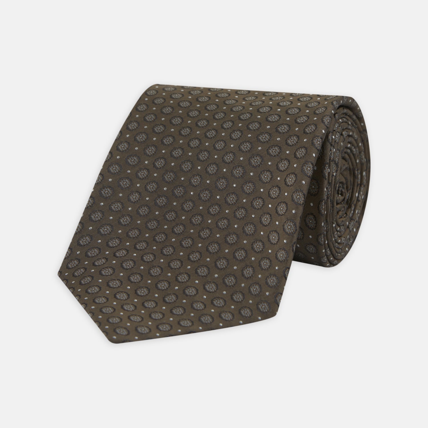 View 1 of product The Brown Floral Spot Silk Tie by Turnbull & Asser features a classic brown base with silver-gray floral spots—an elegant accessory that pairs perfectly with your office shirts.
