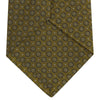 View 4 of product The Gold Floral Spot Silk Tie by Turnbull & Asser showcases a rolled-up design in olive green silk with light floral spots, perfect for adding a refined touch to any office shirt and standing out against a plain white background.