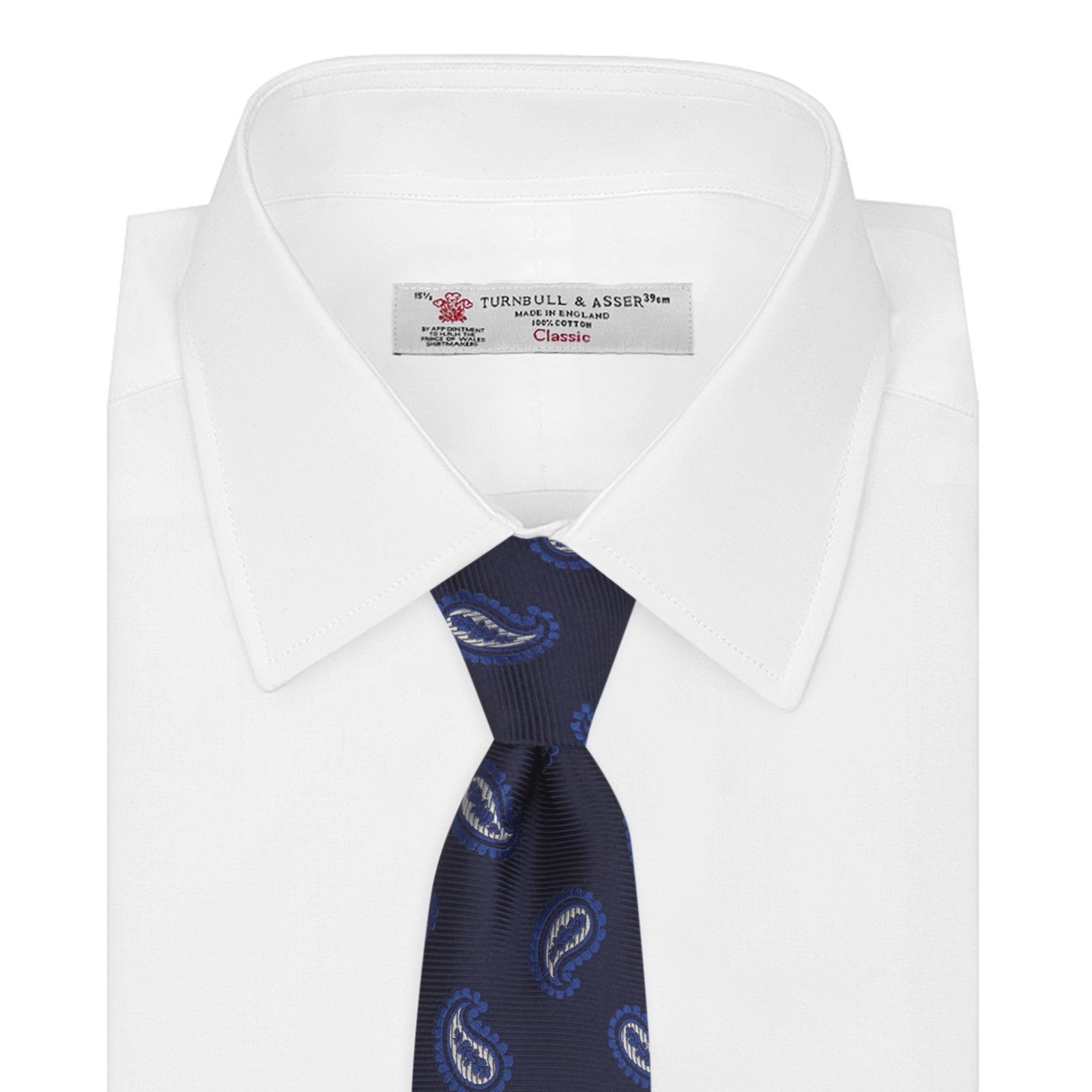 View 2 of product The Turnbull & Asser Navy and Royal Blue Floating Paisley Silk Tie features an elegant blue and white paisley pattern, styled in a rolled presentation on a plain white background.