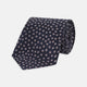The Turnbull & Asser Navy and Pink Paint Spot Silk Tie, rolled at one end and set against a white background, adds a stylish touch to any office shirt with its modern spot pattern.