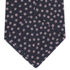 View 4 of product The Turnbull & Asser Navy and Pink Paint Spot Silk Tie, rolled at one end and set against a white background, adds a stylish touch to any office shirt with its modern spot pattern.