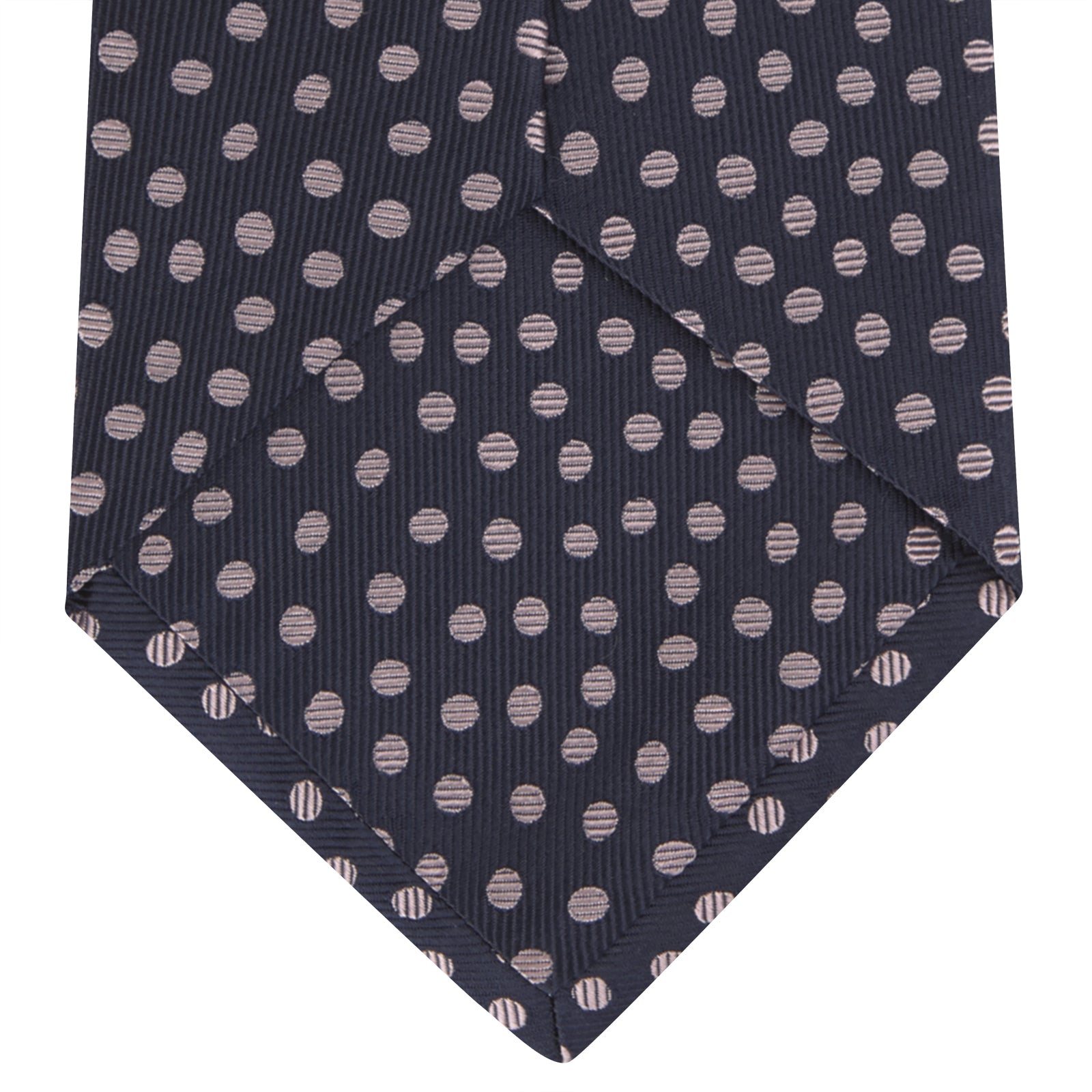 View 4 of product The Turnbull & Asser Navy and Pink Paint Spot Silk Tie, rolled at one end and set against a white background, adds a stylish touch to any office shirt with its modern spot pattern.