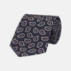 View 1 of product The Turnbull & Asser Navy and Pink Petal Paisley Silk Tie features a repeating petal paisley pattern in pink, shown rolled with the pointed end forward against a plain white background.