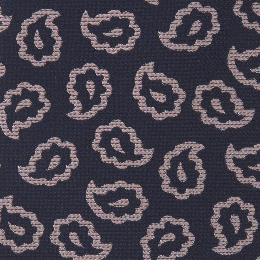 The Turnbull & Asser Navy and Pink Petal Paisley Silk Tie features a repeating petal paisley pattern in pink, shown rolled with the pointed end forward against a plain white background.