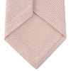 View 4 of product The Turnbull & Asser Light Pink Grenadine Silk Tie features a subtle woven pattern, shown rolled up on a plain white background.