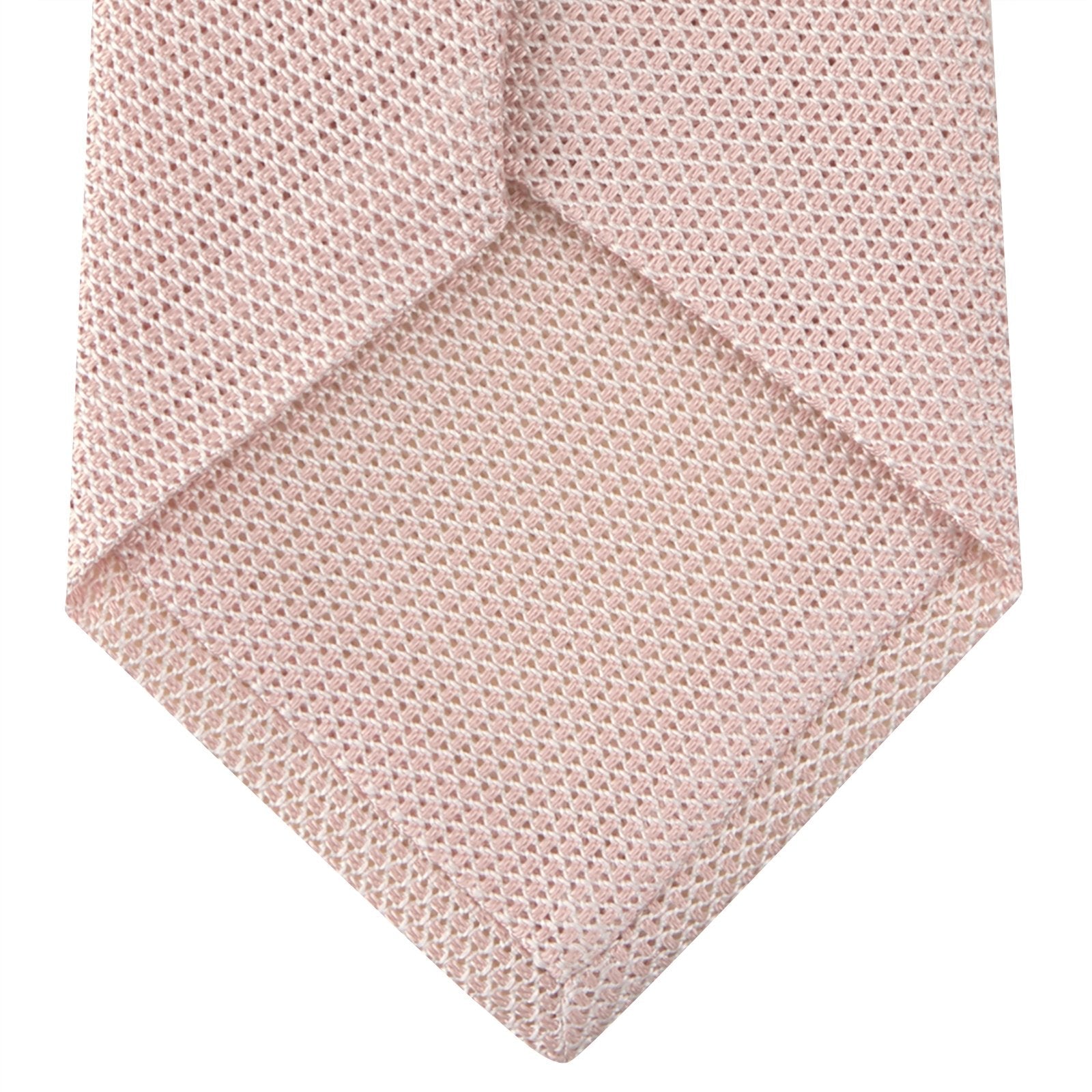 View 4 of product The Turnbull & Asser Light Pink Grenadine Silk Tie features a subtle woven pattern, shown rolled up on a plain white background.