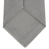 View 4 of product The Turnbull & Asser Light Grey Grenadine Silk Tie features a finely textured checkered pattern and superb dimensional stability, shown rolled up against a plain white background.