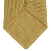 View 4 of product The Turnbull & Asser Gold Grenadine Silk Tie, recognized for its dimensional stability, is shown rolled up against a plain white background.