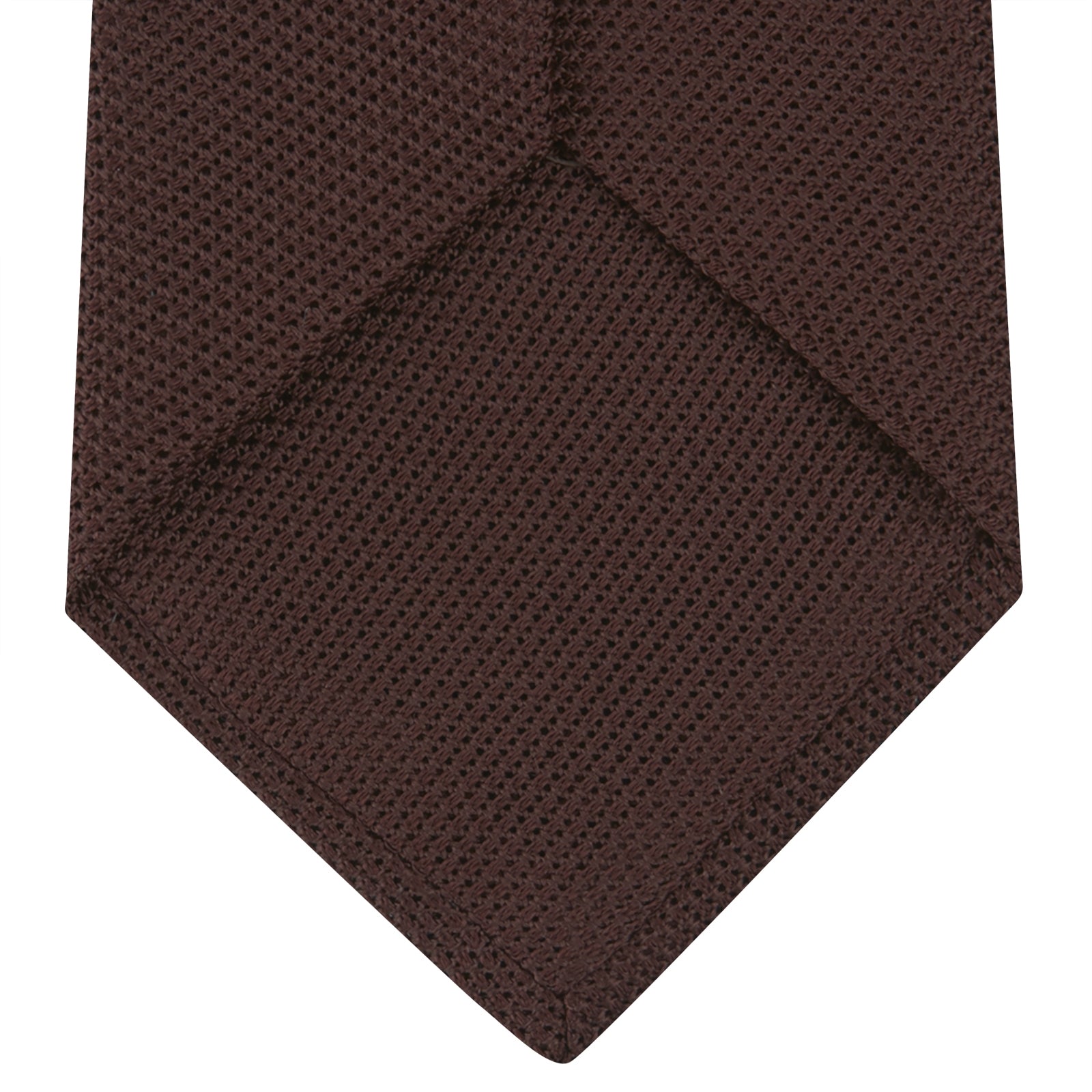 View 4 of product The Turnbull & Asser Burgundy Grenadine Silk Tie, featuring a textured grenadine weave, is rolled up and displayed against a plain white background.