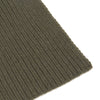 View 2 of product The Turnbull & Asser Khaki Green Knitted Cashmere Scarf is laid flat with one end looped through the other, showcasing its thick, cozy texture—an ideal winter accessory.