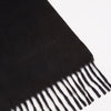 View 2 of product A Turnbull & Asser Black Pure Cashmere Scarf with fringe on both ends, neatly folded and displayed on a plain white background.