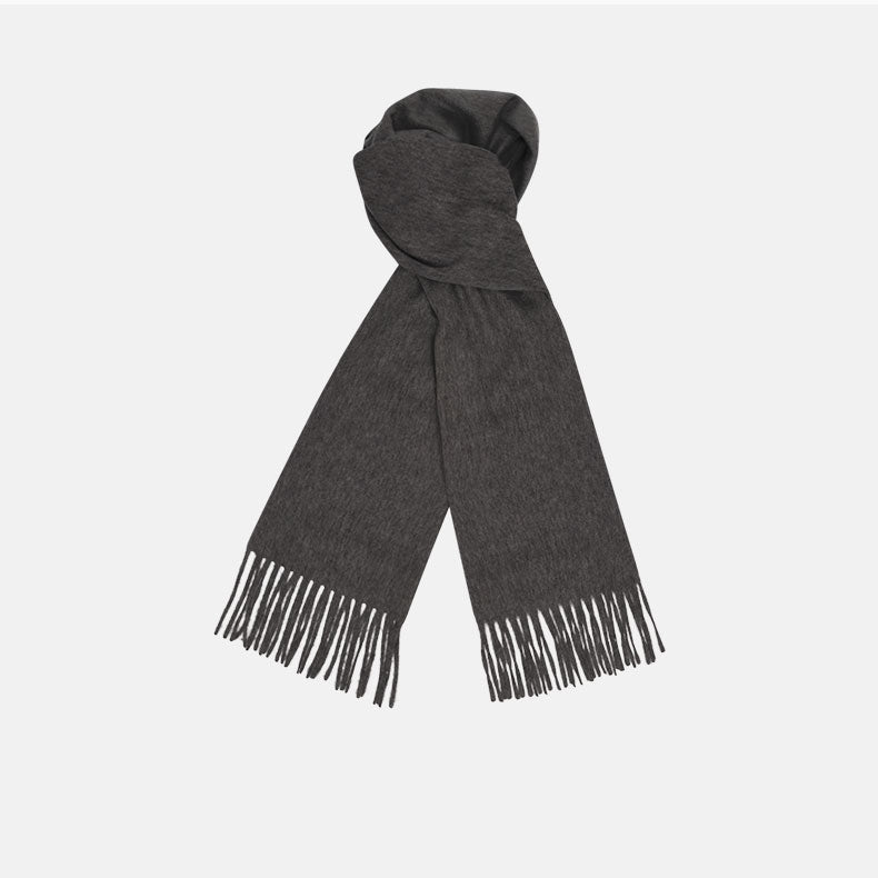 A sartorial essential, the Turnbull & Asser Dark Grey Pure Cashmere Scarf features fringed ends and is shown neatly folded on a plain white background.
