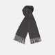 A sartorial essential, the Turnbull & Asser Dark Grey Pure Cashmere Scarf features fringed ends and is shown neatly folded on a plain white background.