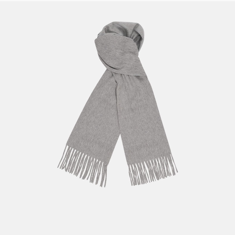 View 1 of product The Flannel Grey Pure Cashmere Scarf by Turnbull & Asser is crafted from soft cashmere, showcased neatly folded with fringed ends on a plain white background.