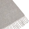 View 2 of product The Flannel Grey Pure Cashmere Scarf by Turnbull & Asser is crafted from soft cashmere, showcased neatly folded with fringed ends on a plain white background.