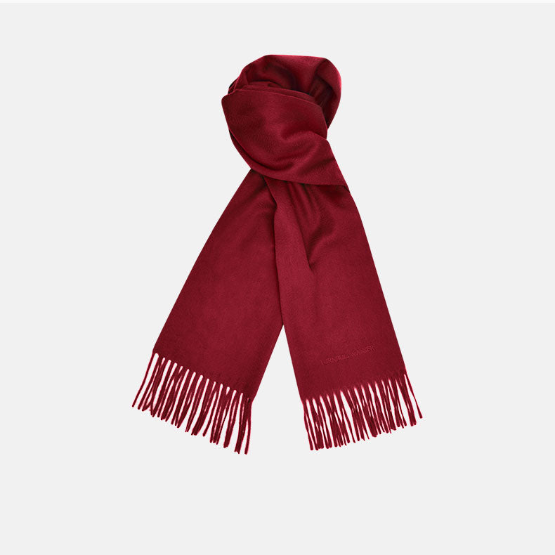 The Turnbull & Asser Bordeaux Pure Cashmere Scarf, in deep red with a soft texture and fringed ends, is neatly folded and displayed on a plain white background.