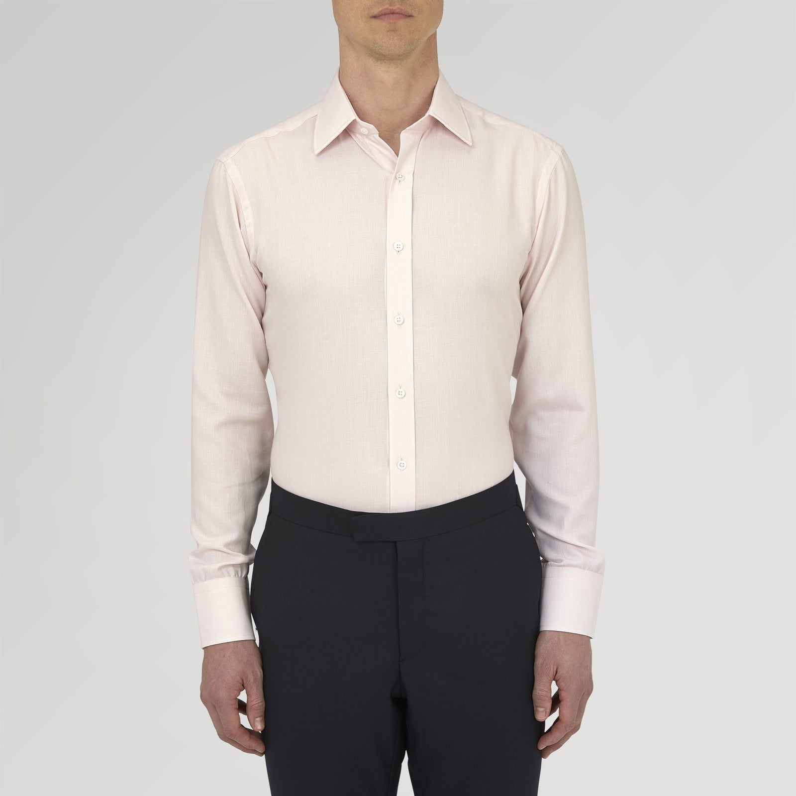 View 2 of product The Turnbull & Asser Pink Cashmere Blend Shirt features a T&A collar and 3-button cuffs, neatly folded with white buttons, displayed on a plain white background.