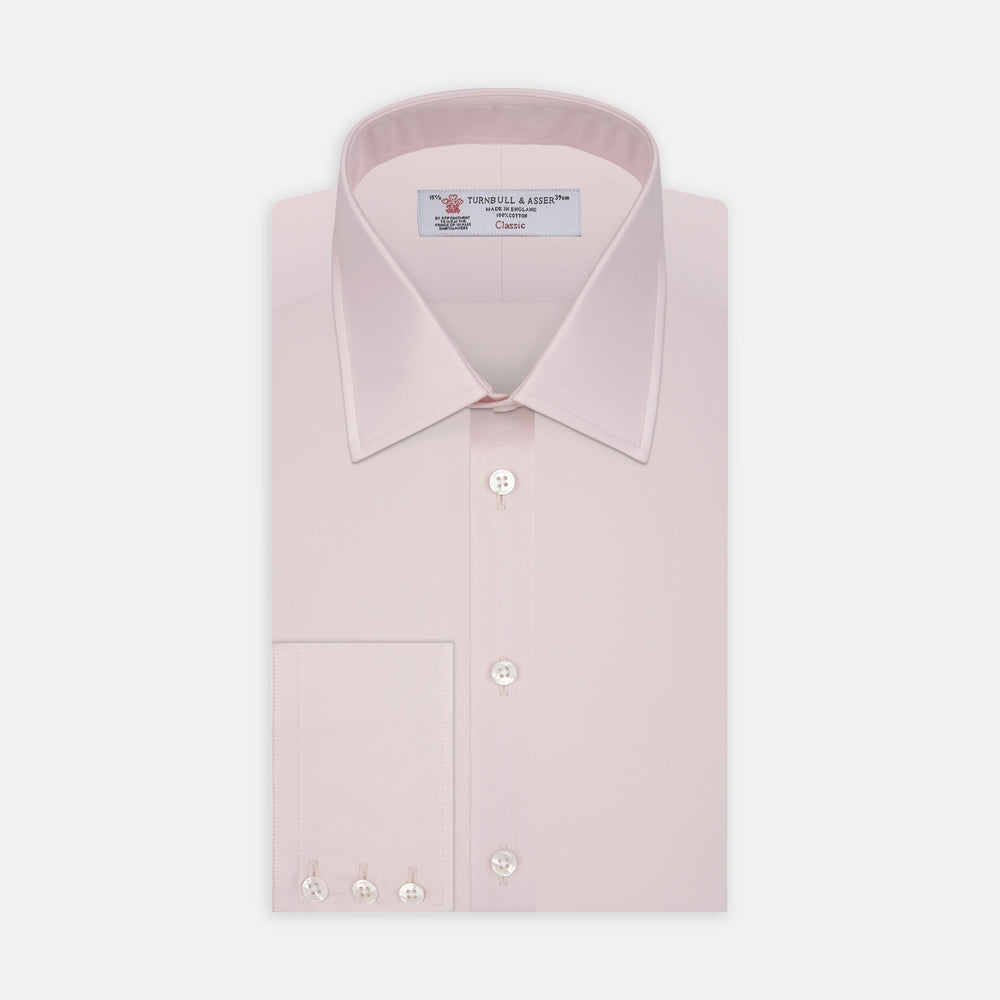 The Turnbull & Asser Pink Cotton Shirt features a T&A collar, 3-button cuffs, and a front pocket. Its clean-cut design is ideal for formal occasions and pairs well with masculine accessories. Displayed against a white background.