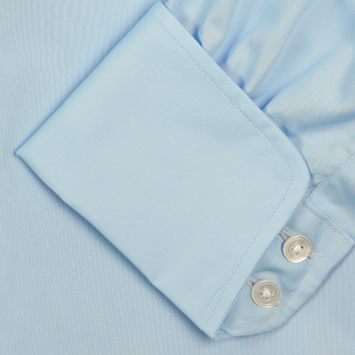 View 6 of product A Turnbull & Asser Blue Shirt with Regent Collar and 2-Button Cocktail Cuffs is neatly folded, featuring white buttons, and displayed on a plain white background.