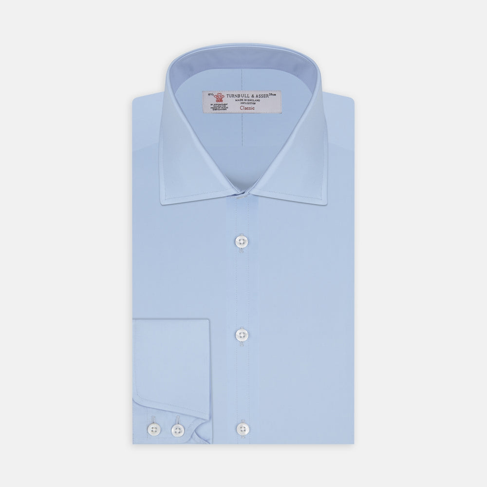 A Turnbull & Asser Blue Shirt with Regent Collar and 2-Button Cocktail Cuffs is neatly folded, featuring white buttons, and displayed on a plain white background.