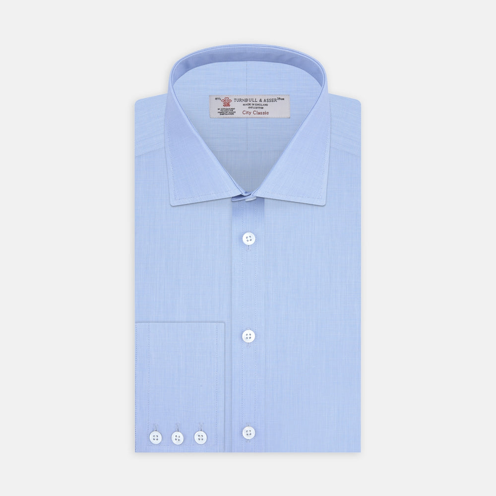 The Turnbull & Asser Light Blue End On End Shirt with Regent Collar and 3 Button Cuffs is shown neatly folded on a white background, featuring a visible chest pocket and brand label inside the collar.