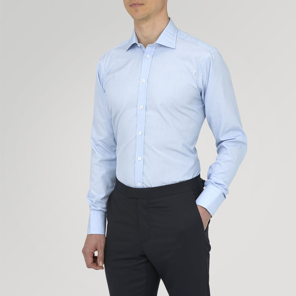 The Turnbull & Asser Light Blue End On End Shirt with Regent Collar and 3 Button Cuffs is shown neatly folded on a white background, featuring a visible chest pocket and brand label inside the collar.