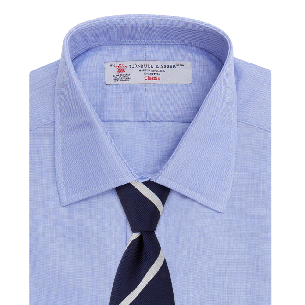 The Turnbull & Asser Blue End-on-End Cotton Shirt features a T&A collar, double cuffs, white buttons, and a chest pocket. Displayed neatly folded on a white background with the label visible at the neck—ideal for refined style.