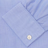 View 6 of product The Turnbull & Asser Blue End-on-End Cotton Shirt features a T&A collar, double cuffs, white buttons, and a chest pocket. Displayed neatly folded on a white background with the label visible at the neck—ideal for refined style.