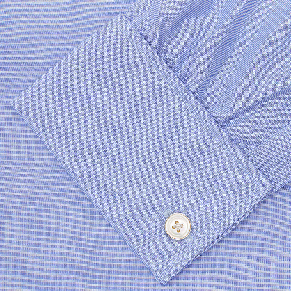 The Turnbull & Asser Blue End-on-End Cotton Shirt features a T&A collar, double cuffs, white buttons, and a chest pocket. Displayed neatly folded on a white background with the label visible at the neck—ideal for refined style.