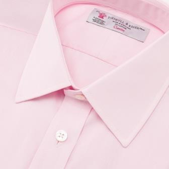 View 5 of product The Turnbull & Asser Pink End-on-End Shirt features a T&A collar, 3-button cuffs, and white buttons—a refined choice for any smart look—shown neatly folded against a plain white background.